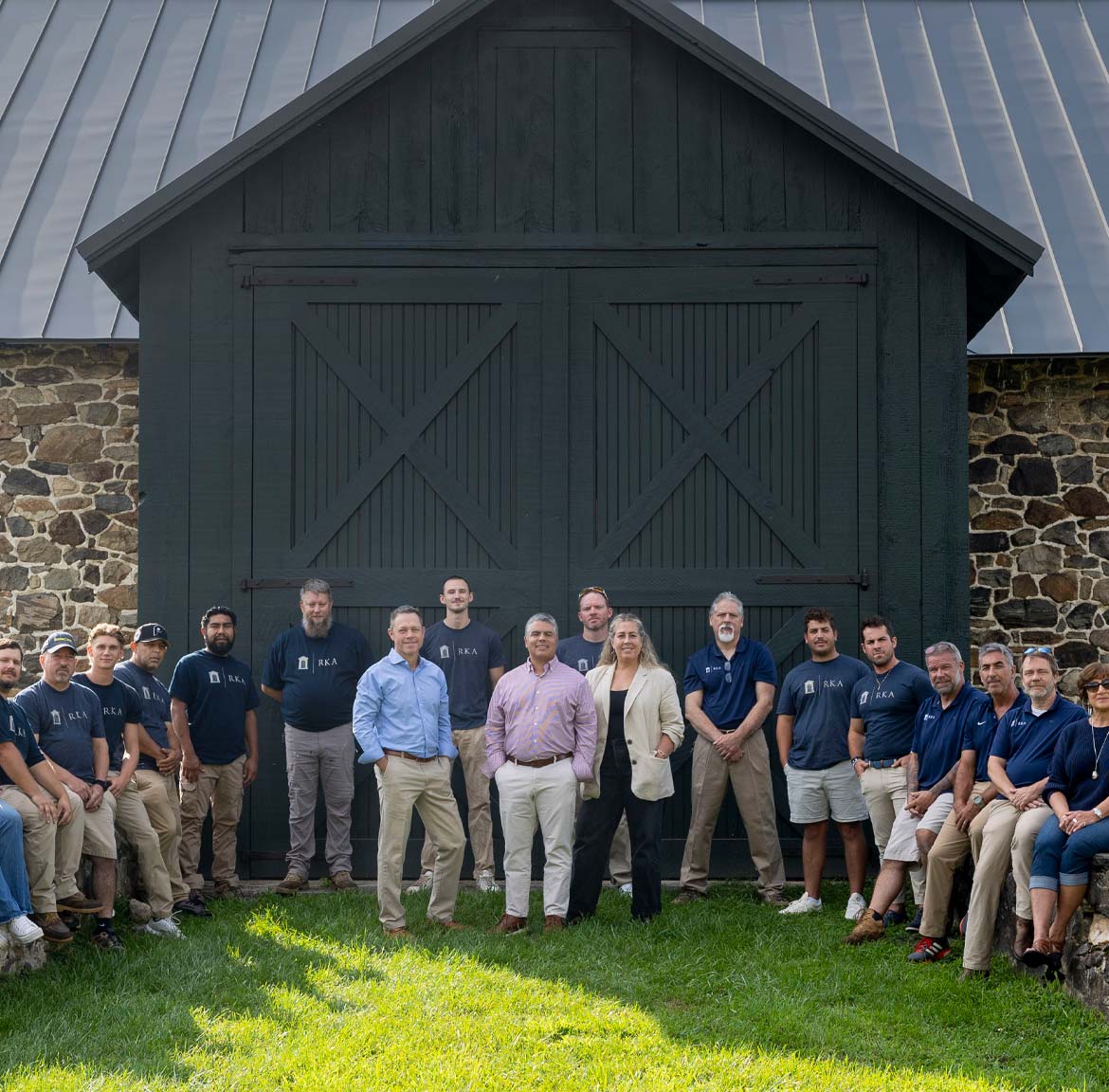 Ranieri & Kerns team in front of a stone barn facade.